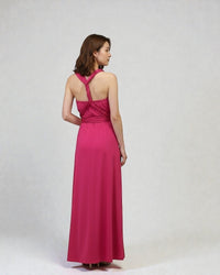 BridesmaidsJP fuchsia pink infinity dress on a model, featuring a convertible halter neckline and flowing maxi skirt.