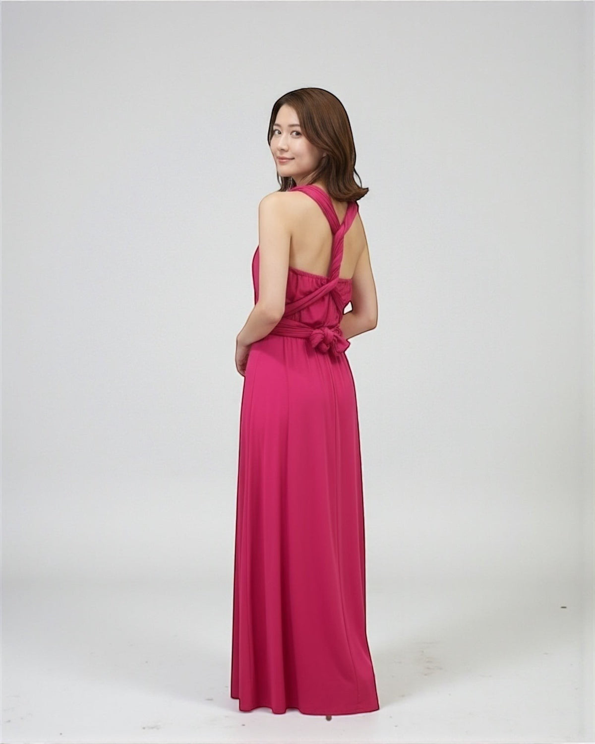 BridesmaidsJP fuchsia pink infinity dress on a model, convertible for multiple styles, floor-length, jersey fabric.
