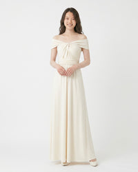 BridesmaidsJP ivory infinity dress with off-the-shoulder neckline and ruched bodice, worn by a model against a white background.