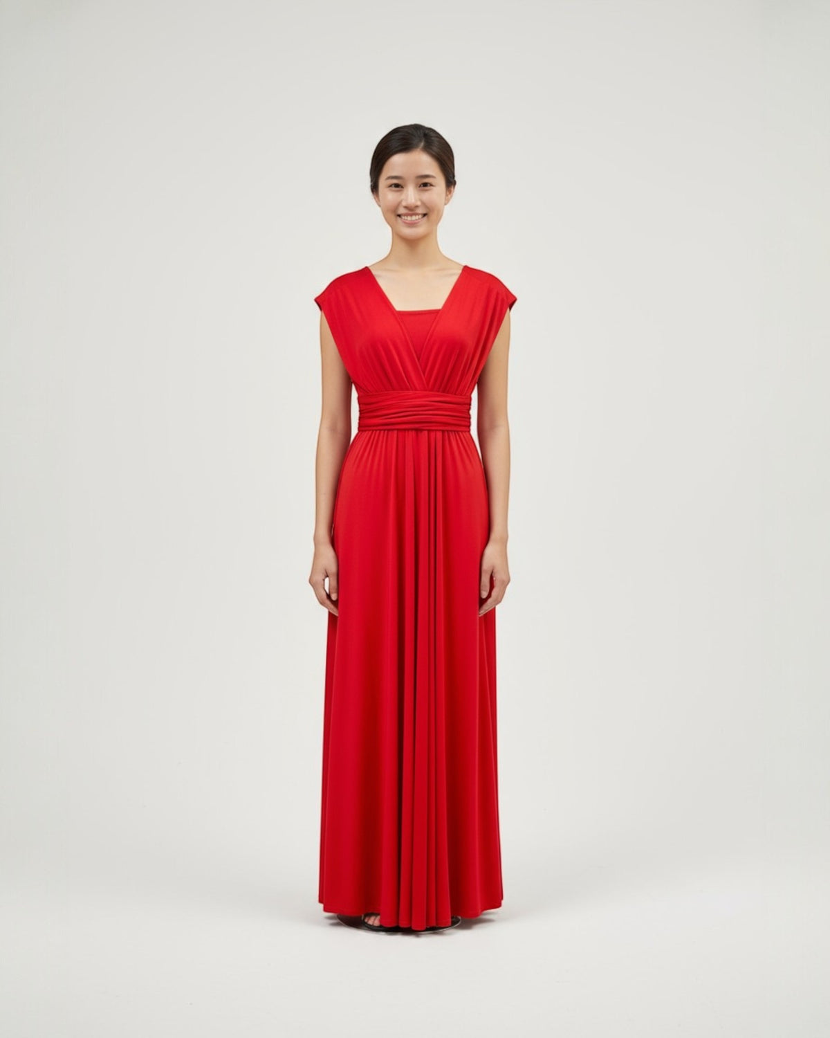 BridesmaidsJP red infinity dress with a sweetheart neckline and ruched waist, made of jersey material. Floor-length.