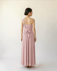 BridesmaidsJP smokey pink infinity dress with one-shoulder strap and bow detail at the back, floor-length.