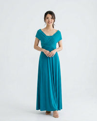 BridesmaidsJP turquoise long infinity dress with a V-neckline and wrap detail, worn by a smiling woman against a white background.